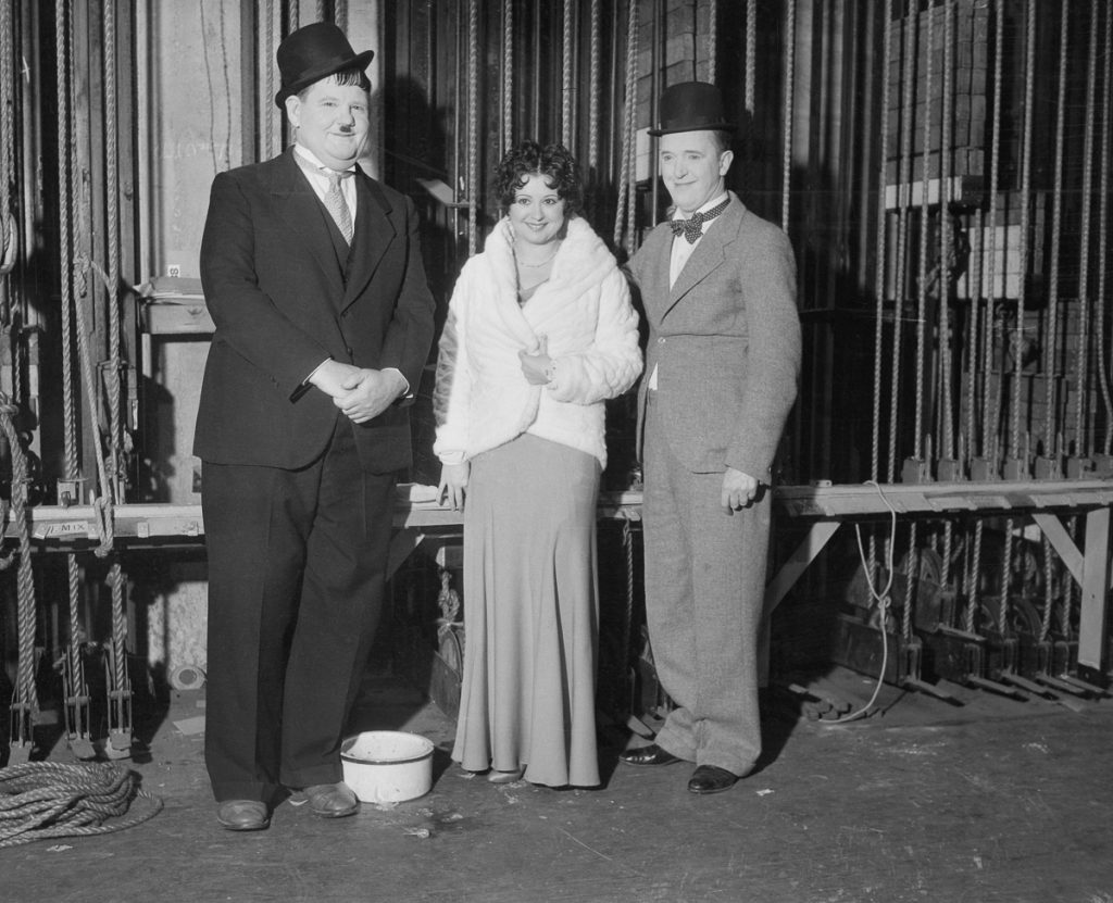 19 Dec 1932, Los Angeles, California, USA --- Original caption: Film folk at Benefit Show. Oliver Hardy, Helen Kane, Boop originator; and Stan Laurel (right) are seen here at the Christmas Benefit Show, staged by a Los Angeles newspaper, at the Shrine Civic Auditorium in Los Angeles. Radio, screen, and stage luminaries attended and participated in the festivities. --- Image by © Bettmann/CORBIS
