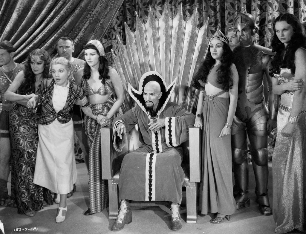 1936: Dale Arden (played by Jean Rogers, 1916 - 1991) struggles in the grip of two servants of Ming the Merciless (Charles Middleton, 1879 - 1949) and his daughter Princess Aura (Priscilla Lawson, 1914 - 1958) in a scene from episode one of the sci-fi classic 'Flash Gordon', directed by Frederick Stephani. (Photo via John Kobal Foundation/Getty Images)