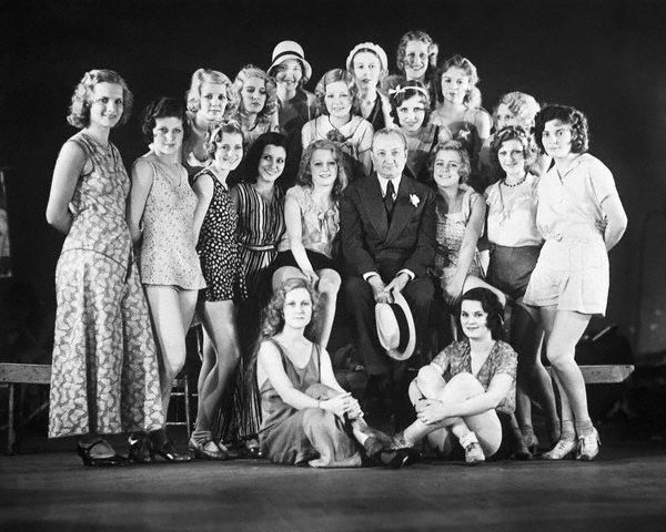 May 20, 1931, New York, New York - Flo Ziegfeld, Dean of Broadway Revue Producers, known for "glorifying the American girl" is shown as he appeared at the Ziegfeld Theater with some of the beautiful American girls who are to be "glorified" in his new follies of 1931. This will be the first follies produced by the veteran showman in several seasons.