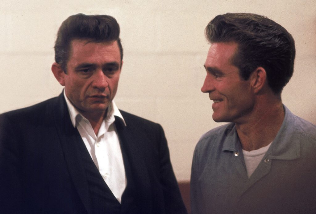 Country singer Johnny Cash talks with Glen Sherley, a prisoner at the Folsom Prison in California on January 13, 1968, the day he recorded his live album "Johnny Cash at Folsom Prison." Sherley wrote the song "Greystone Chapel" on the album. (AP Photo/Dan Poush)