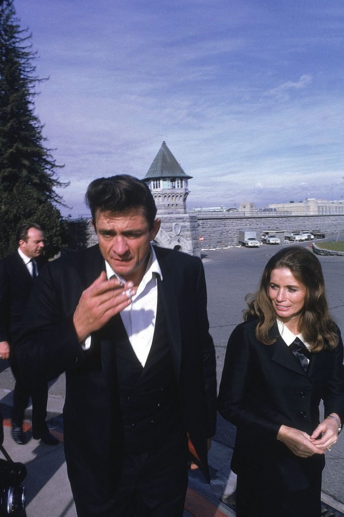 Country singer Johnny Cash walks with June Carter outside the Folsom Prison in California on January 13, 1968, the day he recorded his live album "Johnny Cash at Folsom Prison." (AP Photo/Dan Poush)