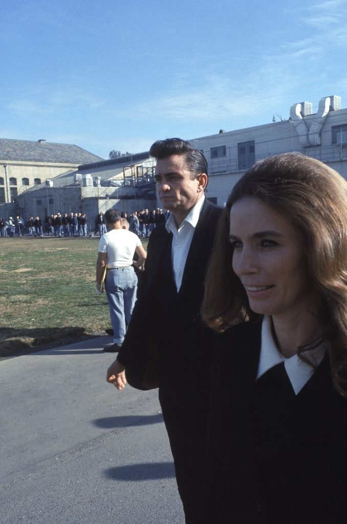 Country singer Johnny Cash walks with June Carter outside the Folsom Prison in California on January 13, 1968, the day he recorded his live album "Johnny Cash at Folsom Prison." (AP Photo/Dan Poush)