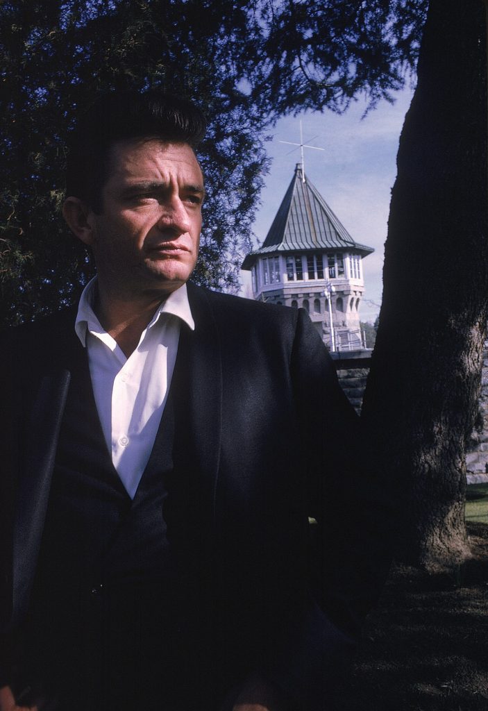 Country singer Johnny Cash poses outside the Folsom Prison in California on January 13, 1968, the day he recorded his live album "Johnny Cash at Folsom Prison." (AP Photo/Dan Poush/Johnny Cash Collection)
