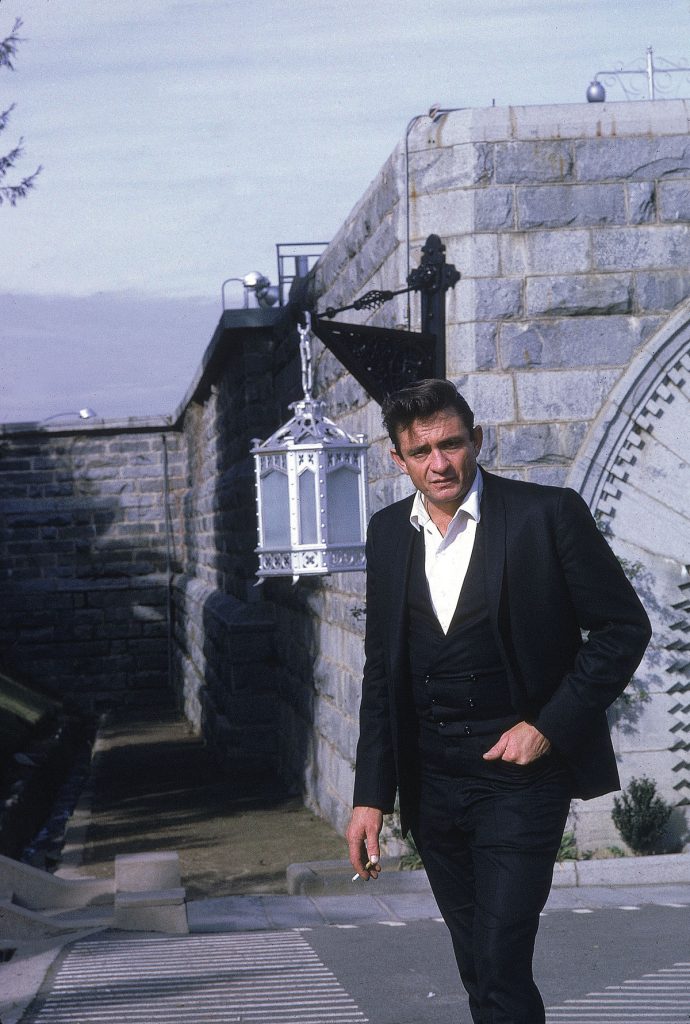 Country singer Johnny Cash poses outside the Folsom Prison in California on January 13, 1968, the day he recorded his live album "Johnny Cash at Folsom Prison." (AP Photo/Dan Poush)