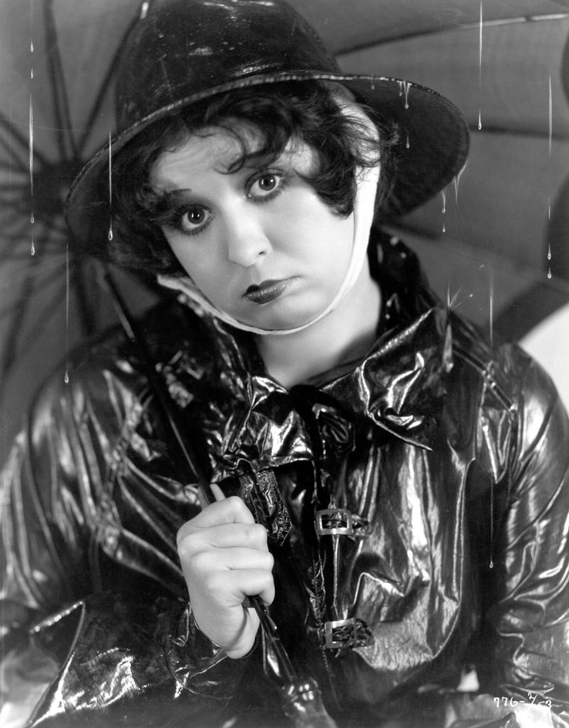 circa 1934: Helen Kane (1904-1966), formerly Helen Schroeder, the original 'boop-boopa-doop' singer and actress signed by Paramount, sheltering beneath an umbrella. (Photo by Otto Dyar/Hulton Archive/Getty Images)