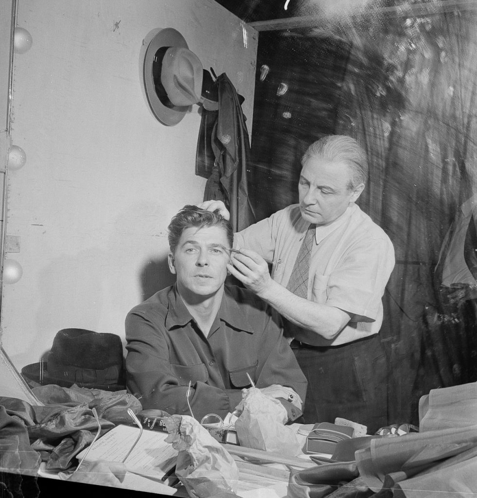 NEW YORK - DECEMBER 7: Nash Airflyte Theater of episode 'The Case of the Missing Lady' Ronald Reagan with make-up man Frederick Van Der Linden (Photo by CBS via Getty Images) *** Local Caption *** Ronald Reagan;Frederick Van Der Linden
