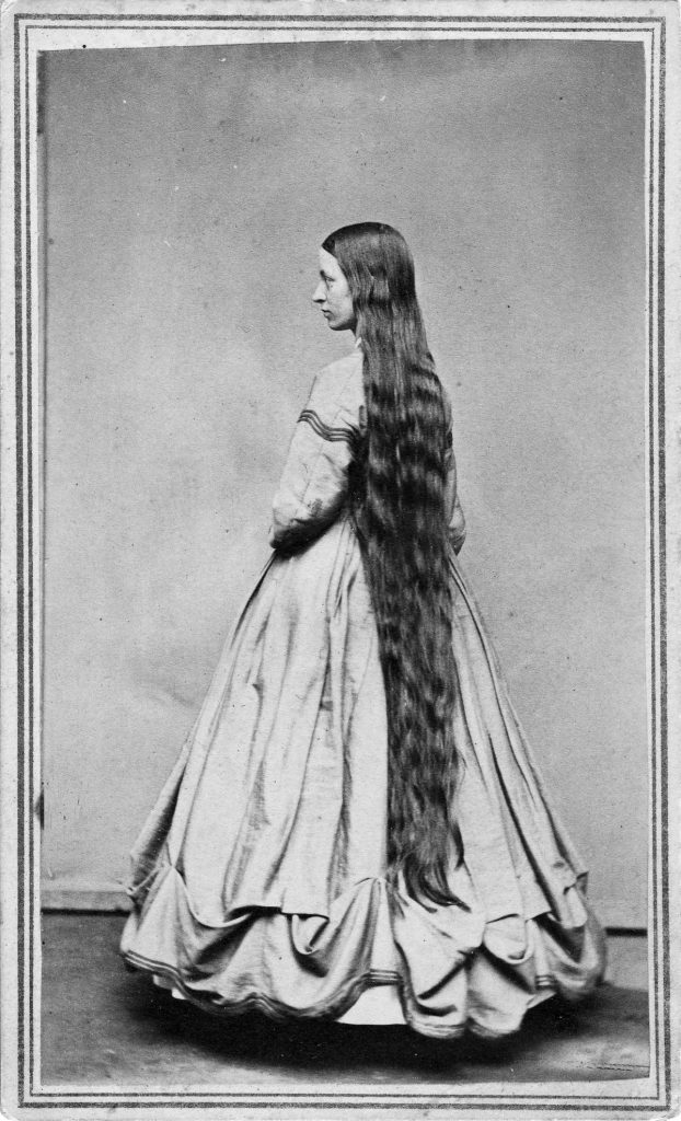UNITED STATES - CIRCA 1865: A woman poses to show her long hair in a studio around 1865 in an unknown location. (Photo Reproduction by Transcendental Graphics/Getty Images) *** Local Caption ***